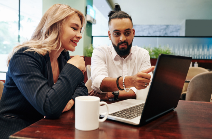 Caterers strategizing their marketing efforts on a laptop