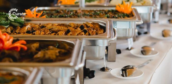 An array of catered food on serving trays