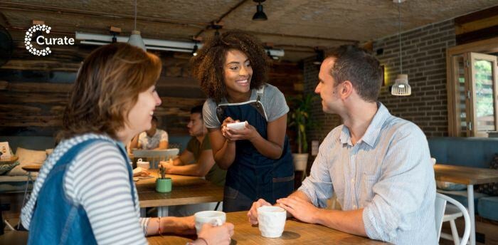 A waitress happily taking food orders from customers