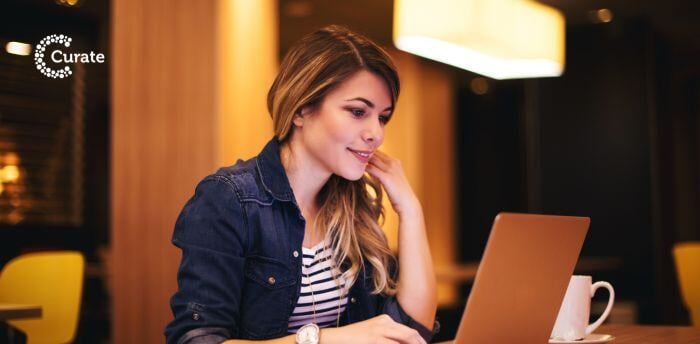 A restaurant social media manager working on a laptop